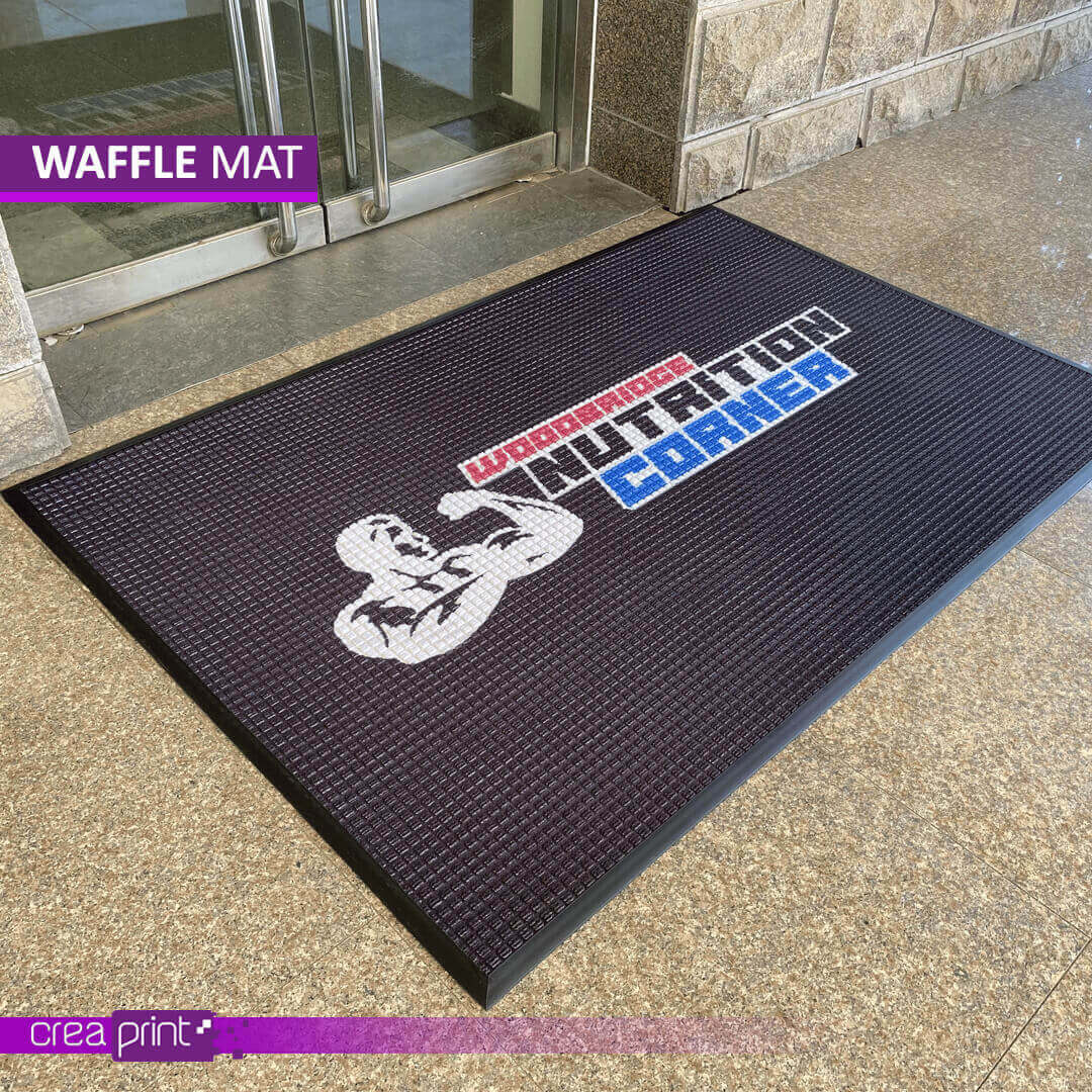 Custom waffle pattern logo mat with slip-resistant backing, designed for durability and high-traffic areas, perfect for branding and floor protection.