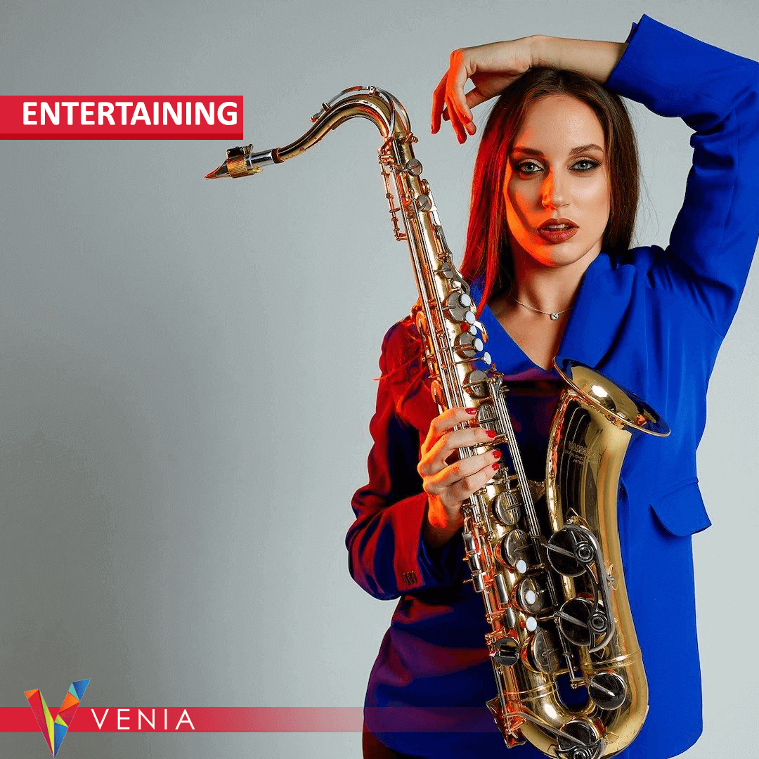 Female saxophonist performing at a wedding or corporate event, booked through Venia.