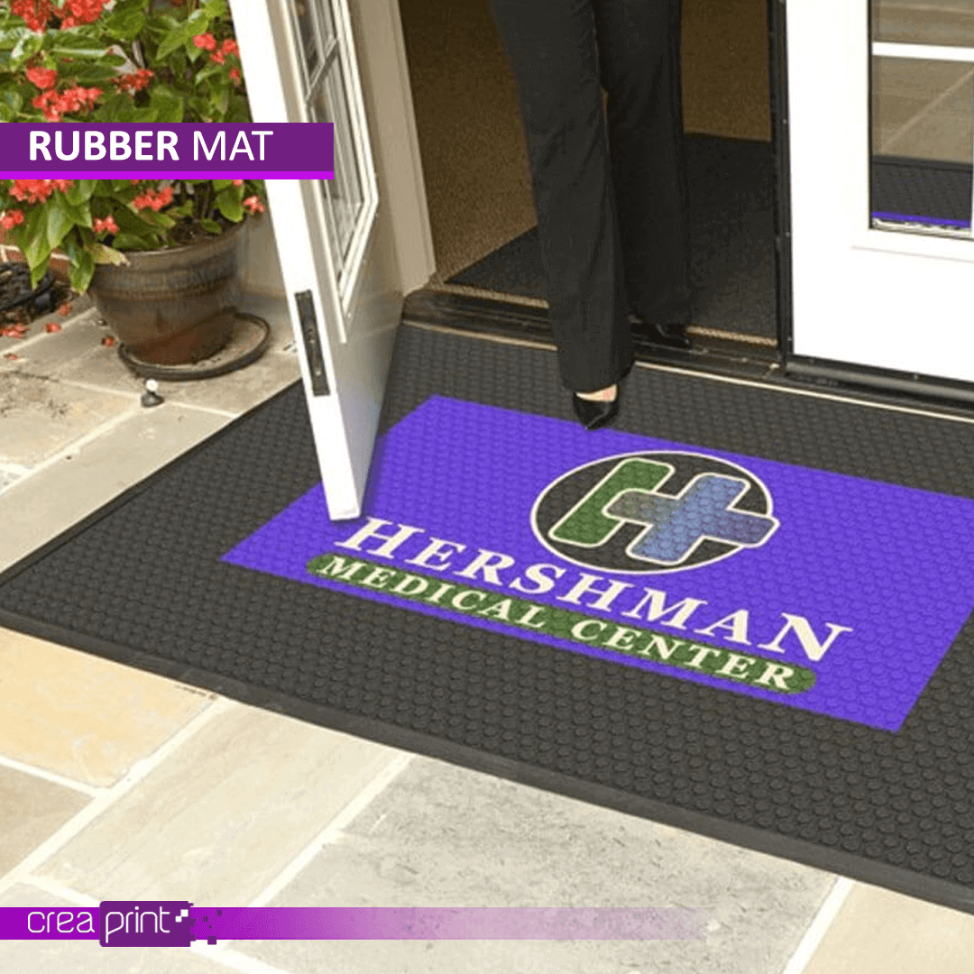 Custom-printed door mats by Creaprint for indoor and outdoor use, available in various sizes and designs.