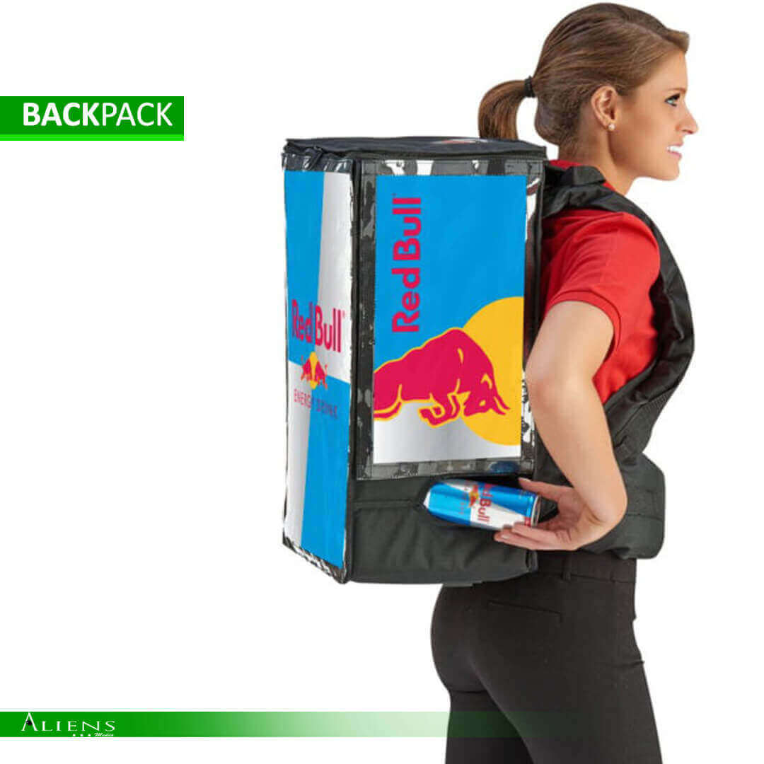Sampling backpack with branded design distributing products at an outdoor event.