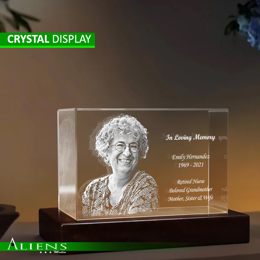 A 3D crystal award engraved with intricate designs using laser technology.