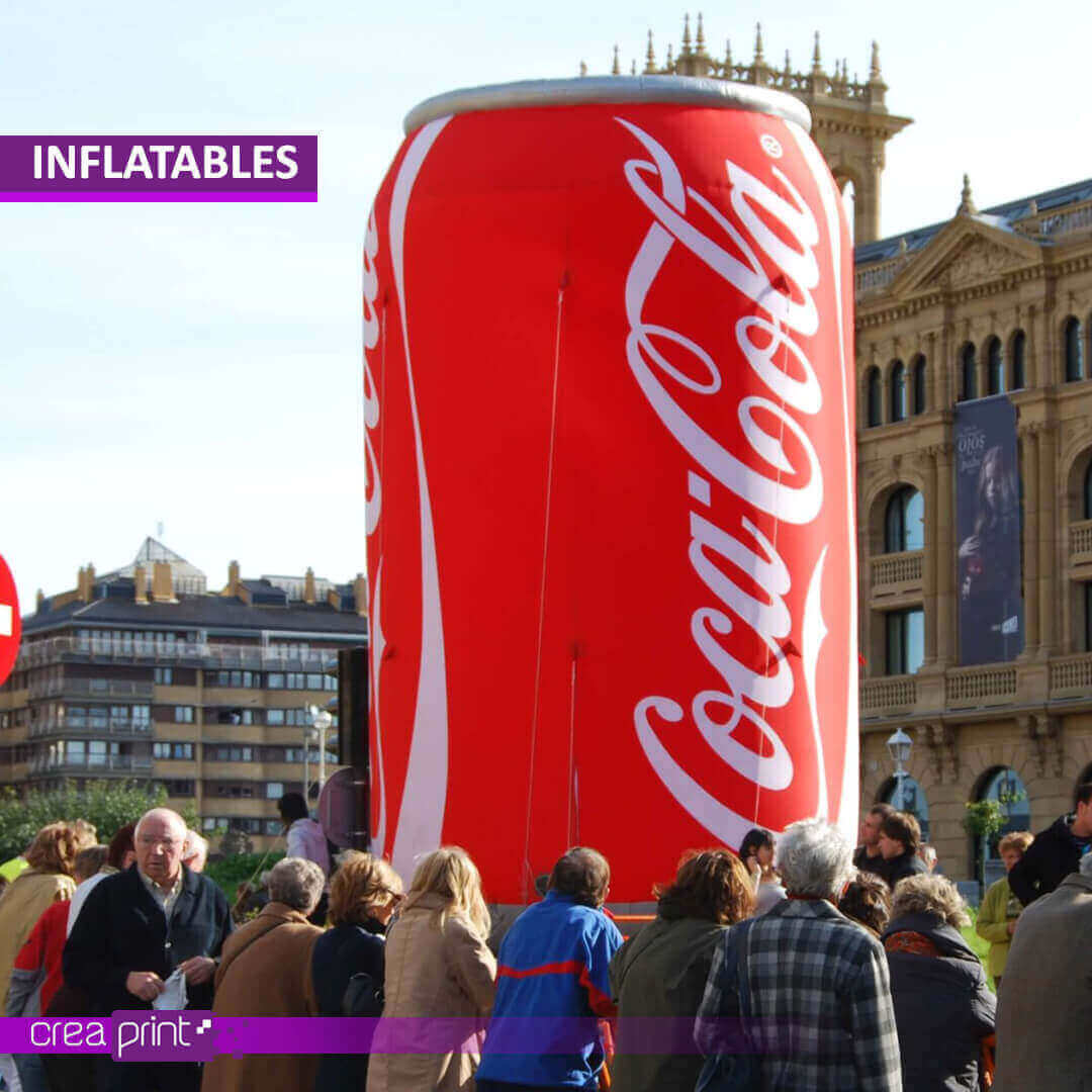 A vibrant image of a giant inflatable bottle replica at a promotional event, attracting attention and generating excitement among attendees.