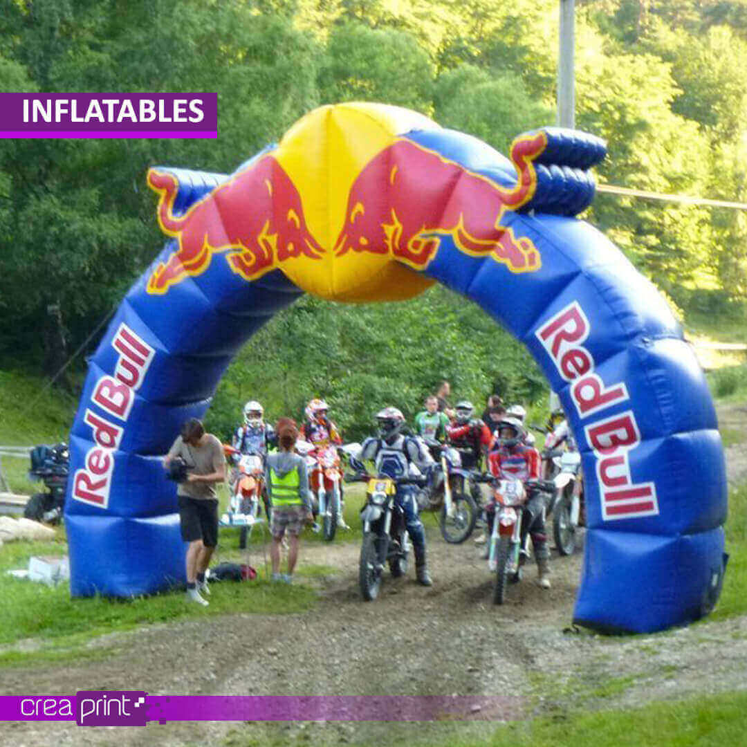 A vibrant image of a custom-printed inflatable archway at a grand opening event, showcasing its impressive size and eye-catching design. Attendees are walking through the archway, creating a sense of excitement and anticipation.