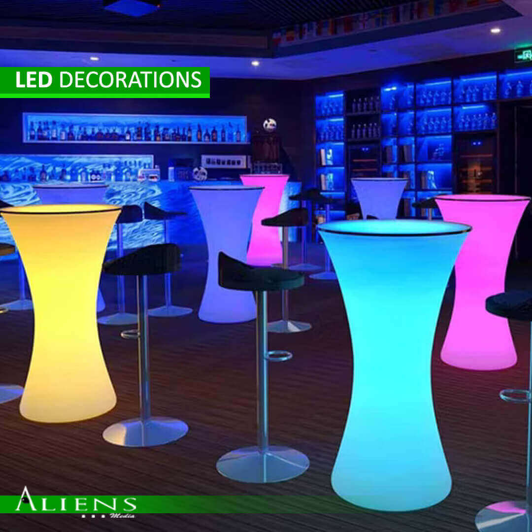 A couple dancing on a glowing LED dance floor.