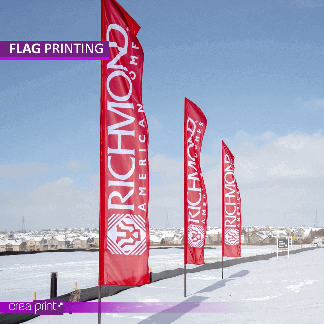 Custom outdoor tear flag fluttering in the wind, showcasing a vibrant logo and design.
