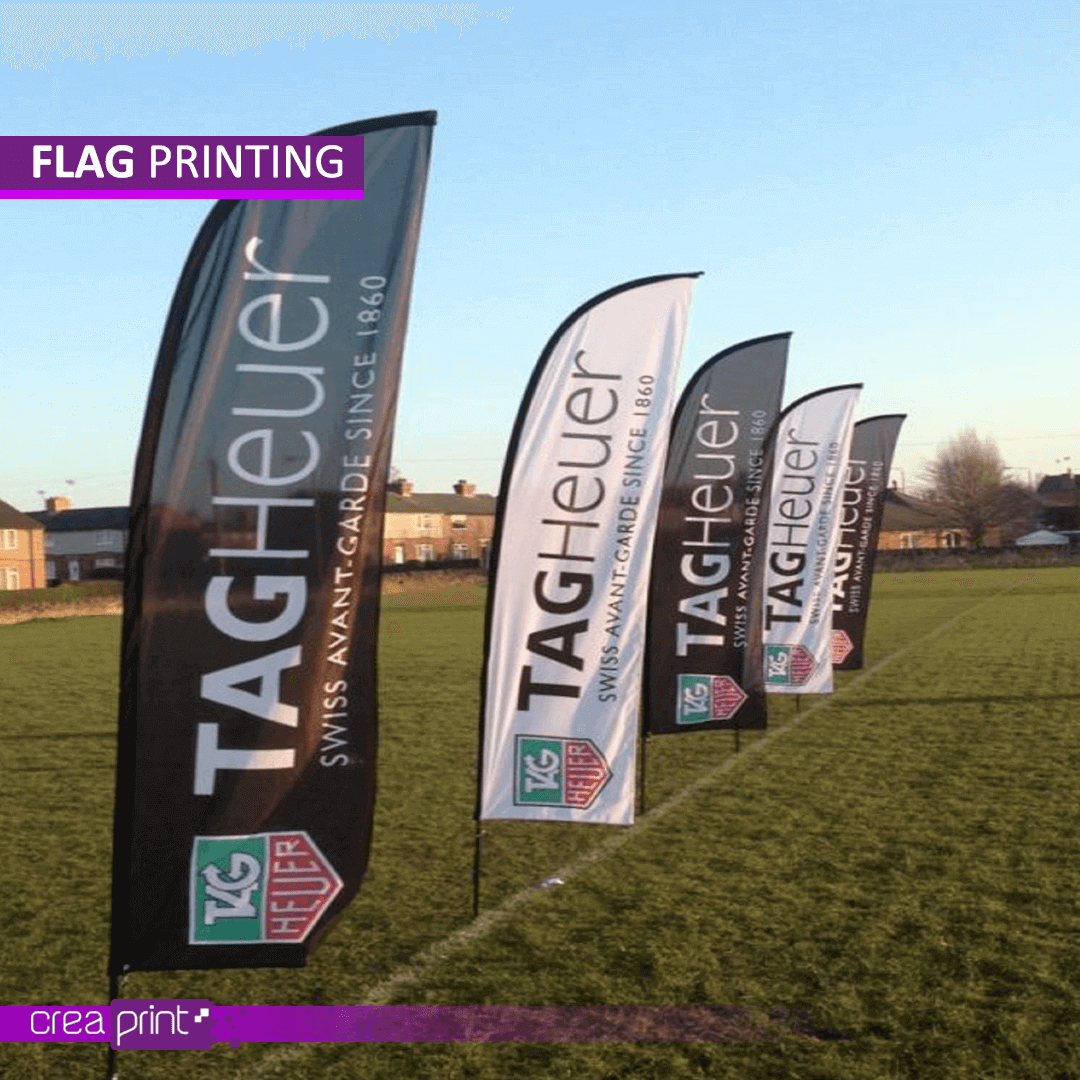 High-quality custom-printed flags waving in the wind, showcasing vibrant designs and logos.