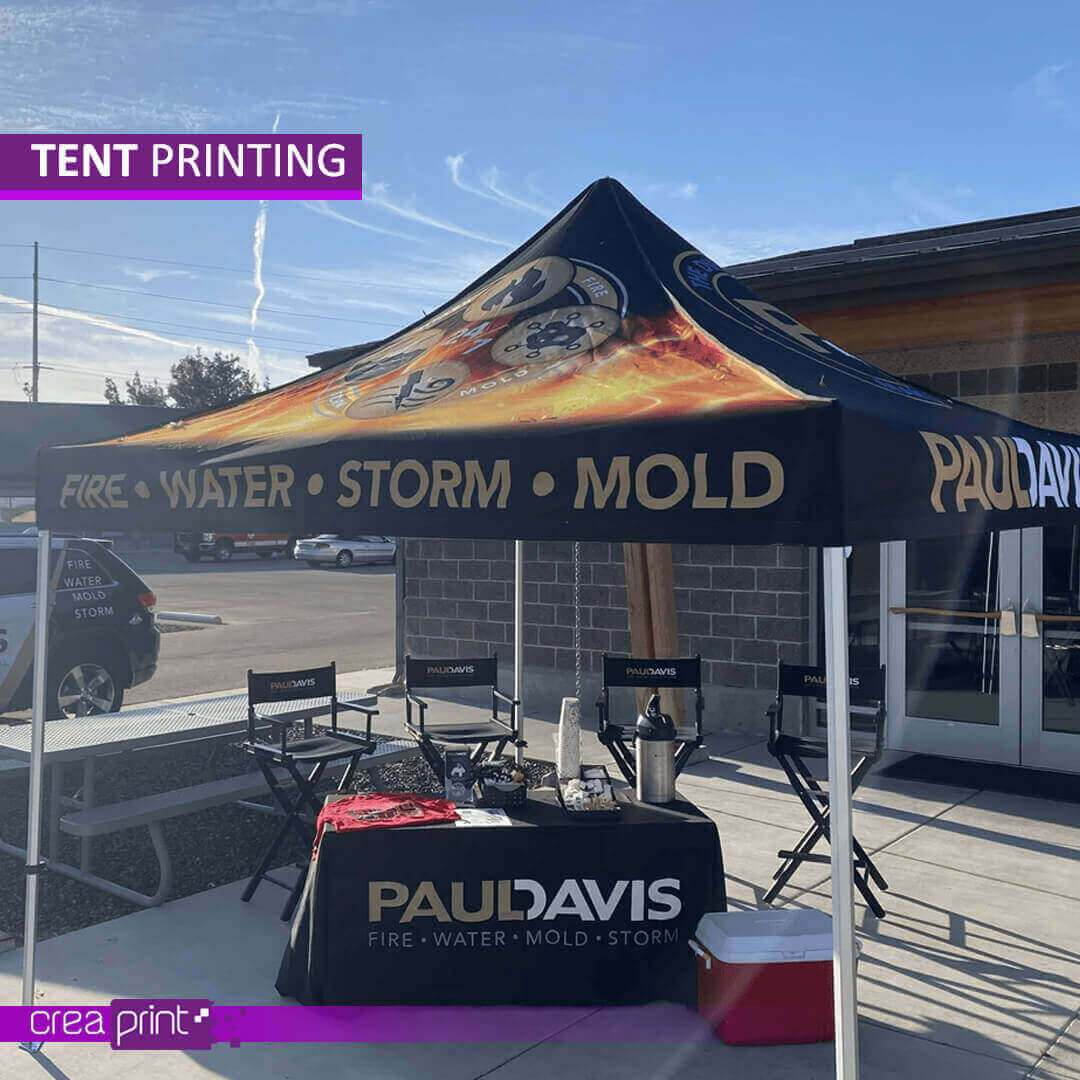 A vibrant image of a custom-printed pop-up tent with a unique design, showcasing its eye-catching appeal at a bustling outdoor event. Attendees are drawn to the vibrant colors and engaging visuals.