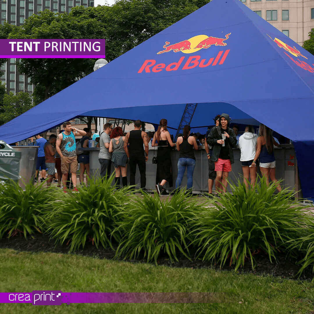 A vibrant image of a custom-printed star tent with a unique design, showcasing its eye-catching appeal at a bustling outdoor event. Attendees are drawn to the vibrant colors and engaging visuals.