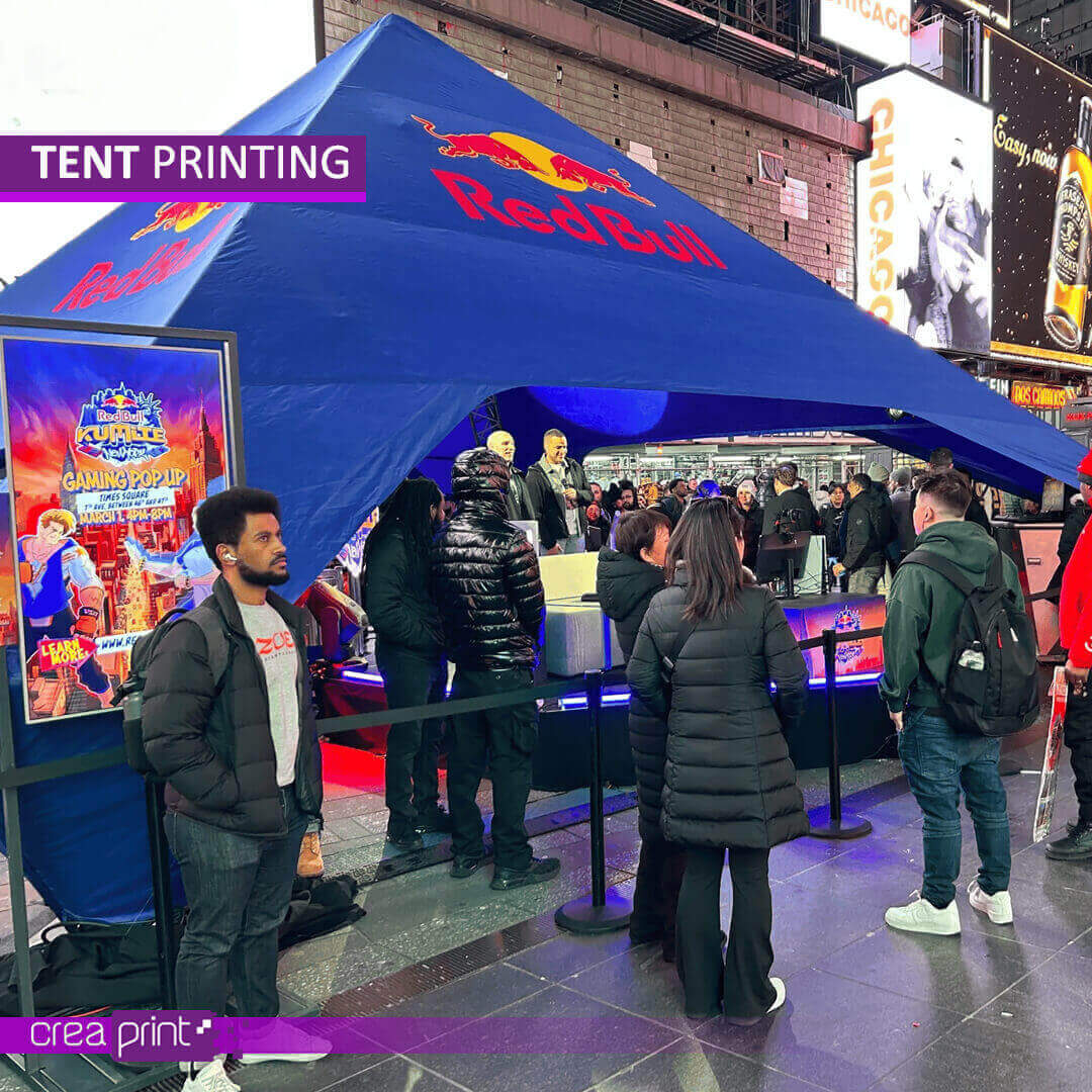 A vibrant image of a custom-printed pop-up tent with a unique design, showcasing its eye-catching appeal at a bustling outdoor event. Attendees are drawn to the vibrant colors and engaging visuals, interacting with the brand representatives within the tent.