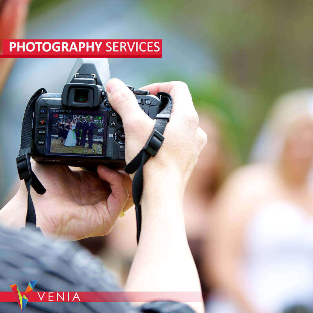 Professional photographers and videographers from Venia Agency capturing stunning visuals at a dynamic event.